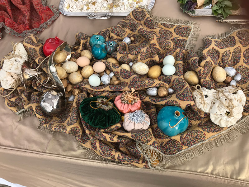 decorated eggs, nuts, ceramic pomegranates on metallic fringe