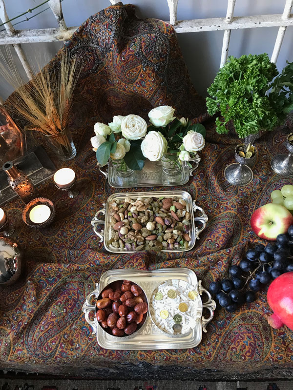 sofreh Mehregan with dainty garden roses, mixed dried fruit and nuts