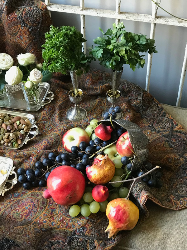 sofreh Merehgan with herbs, gilded coins, and fruits