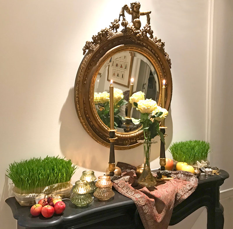 ornate mirror over a black marble mantelpiece