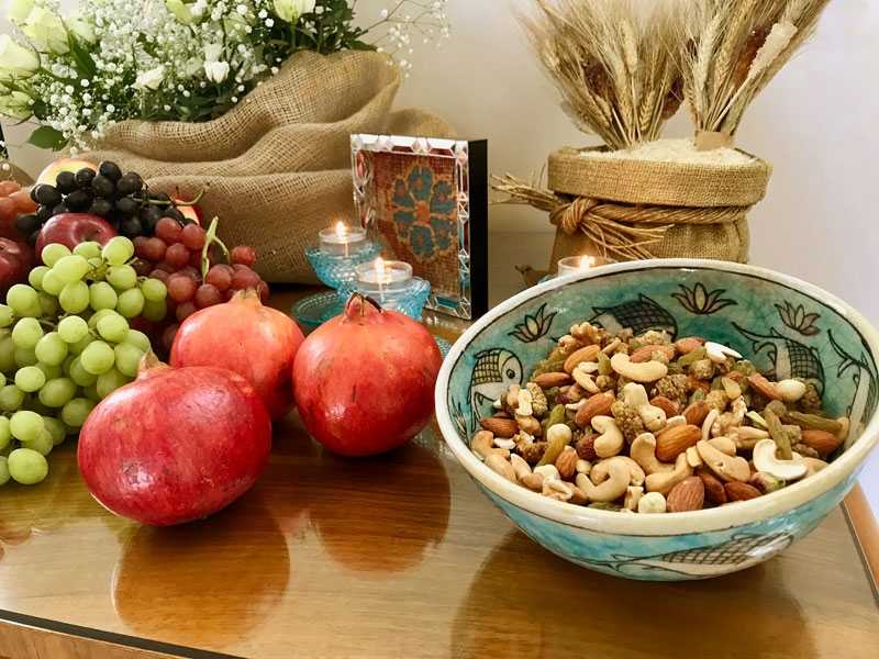 shiny pomegranates and container of mixed dried fruit and nuts