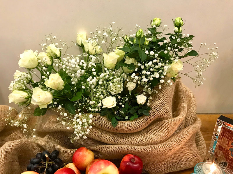 bouquet of miniature and spray cream roses and baby’s breath