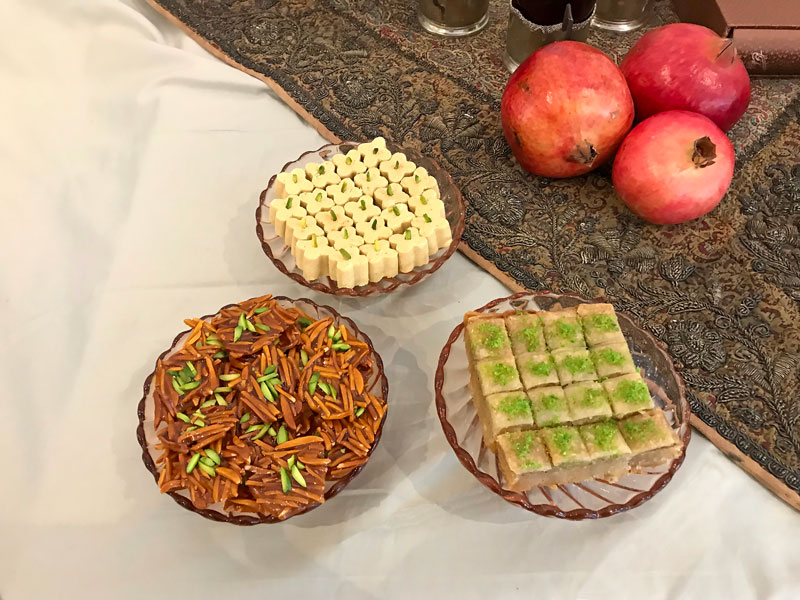 Persian sweets and some whole pomegranates