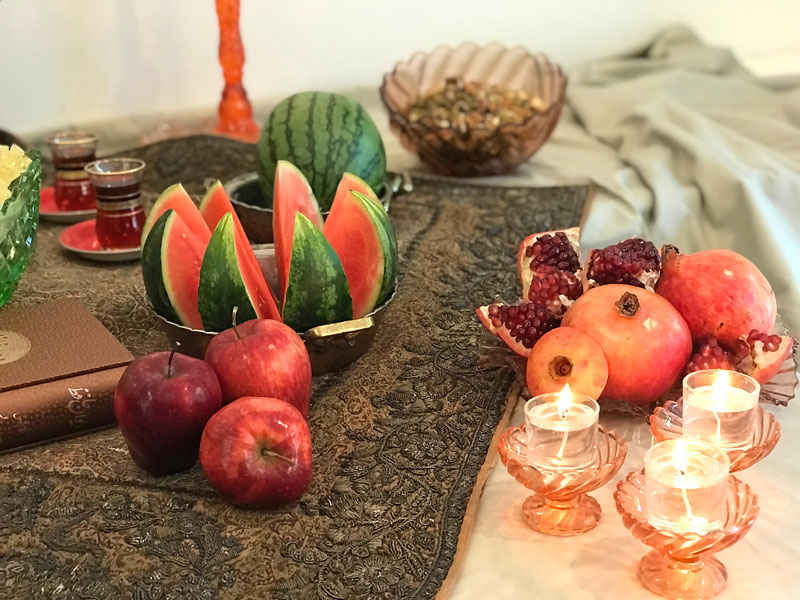 watermelons, arranged in traditional copper vessels, pomegranates