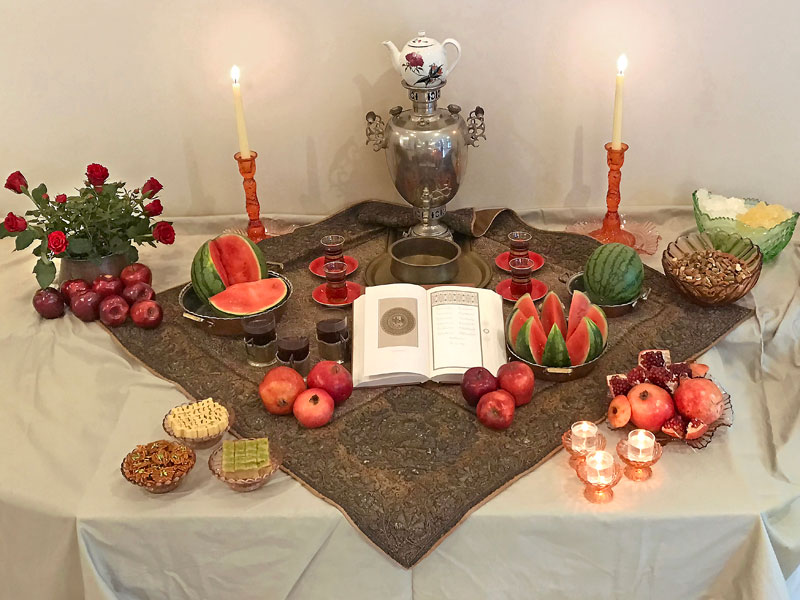 termeh, Persian sweets, crystal sugar, nuts, red fruits, flowers, flames and a divan-e Hafez