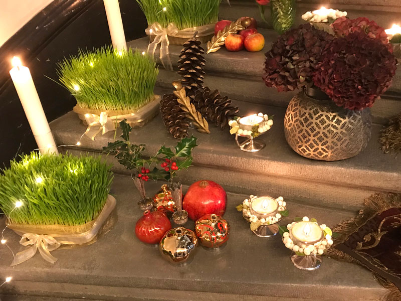 Pomegranate, silver vases, holly, tea lights