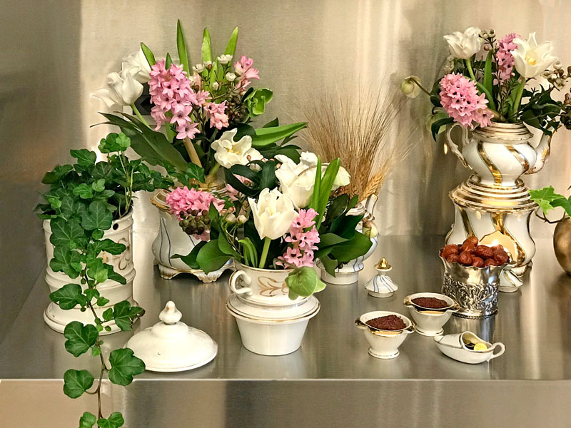 bouquets of white tulips, pink hyacinths, hellebores, and berried ivy