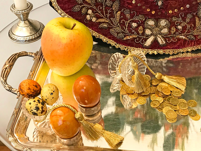 apple, decorated eggs, gilded coins and delicate gold tassels