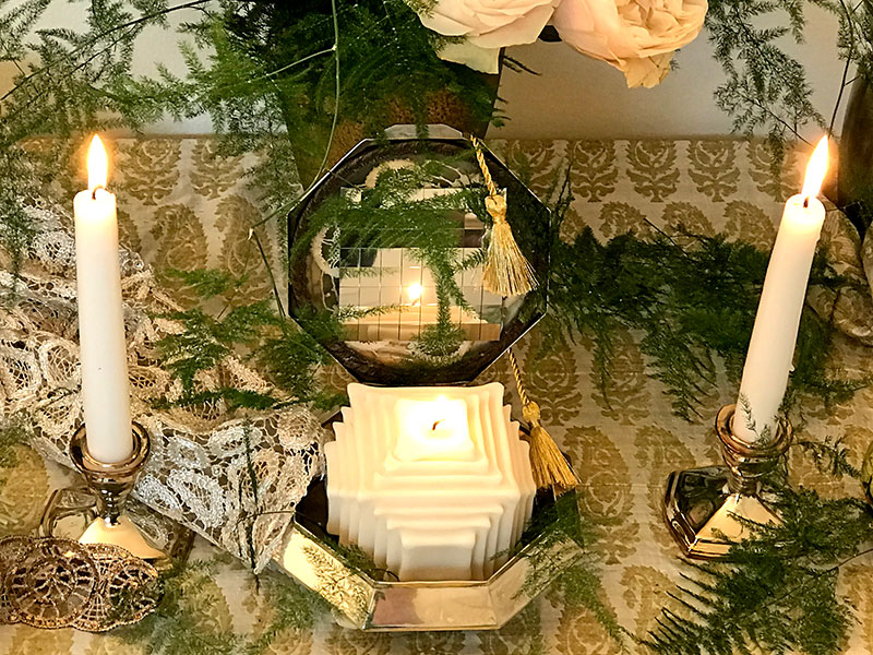 silver art deco box holds a single distinctive candle