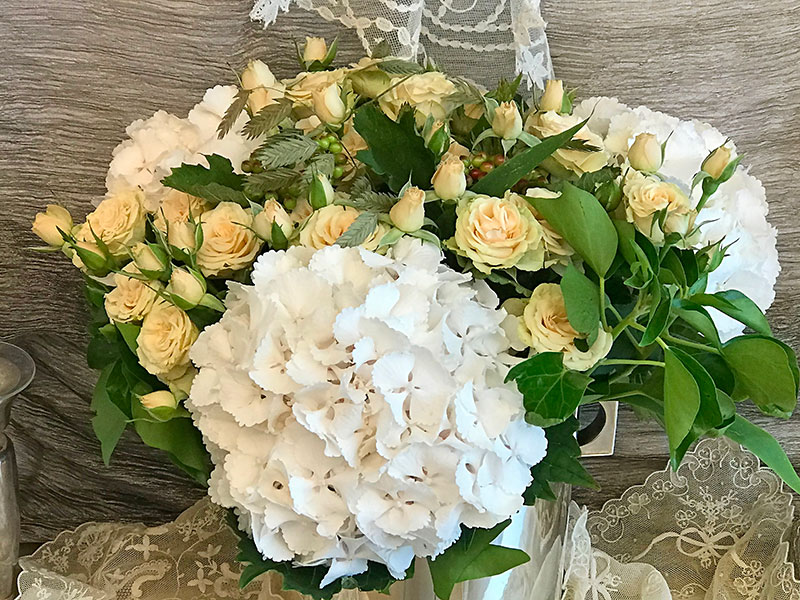 bouquet of white ball hydrangeas, roses, and ivy