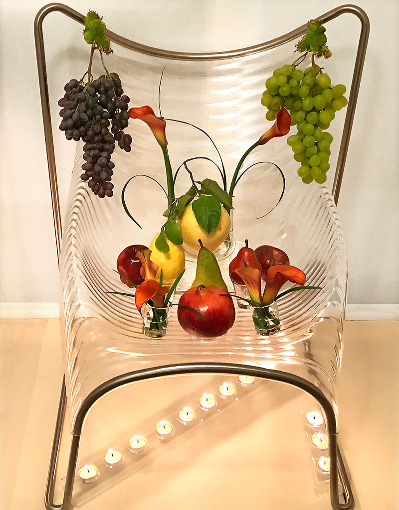 fruit, flowers &amp; foliage, with tea lights, on chair displayed