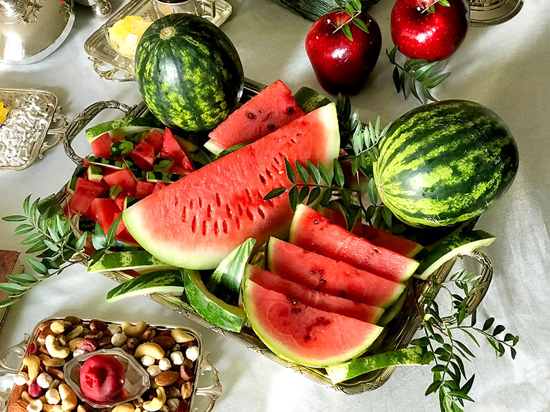 whole and cut watermelons embellished with foliage