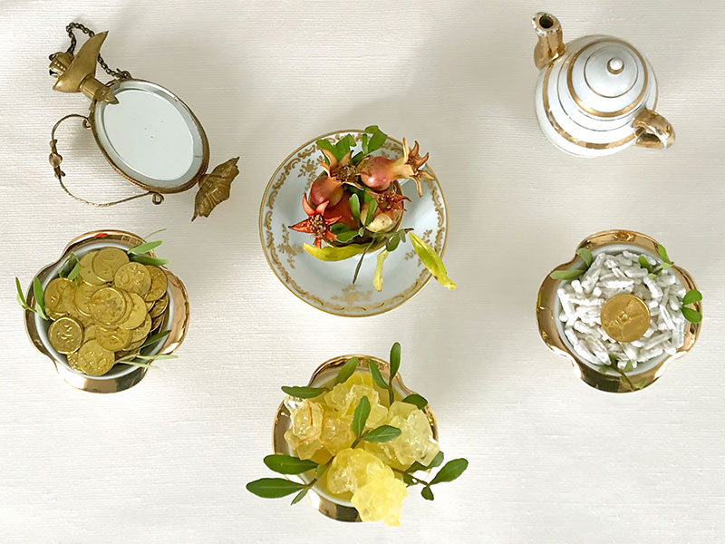 urn, gold teapot, pomegranate sprigs, coins, and crystal sugar
