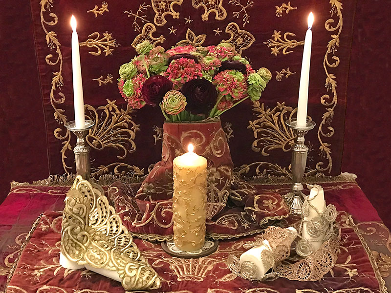 sofreh with deep red velvet, candles, ranunculi bouquet