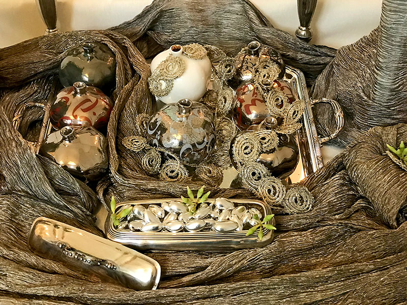 sofreh with ceramic pomegranates, silver and gold textiles