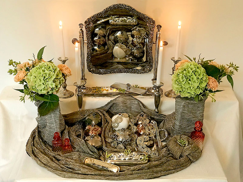 sofreh with flowers, candles, mirror, coins, almonds