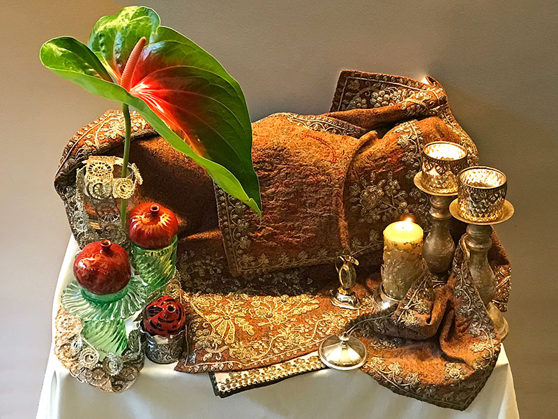 compact sofreh pomegranates, rosewater, candles