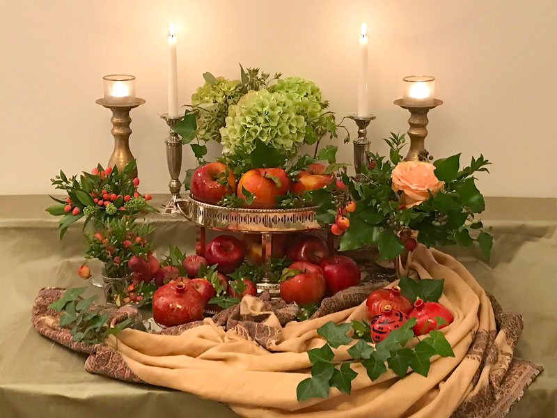 Sofreh with variety of apples in a two-tiered, antique silver-plated vessel
