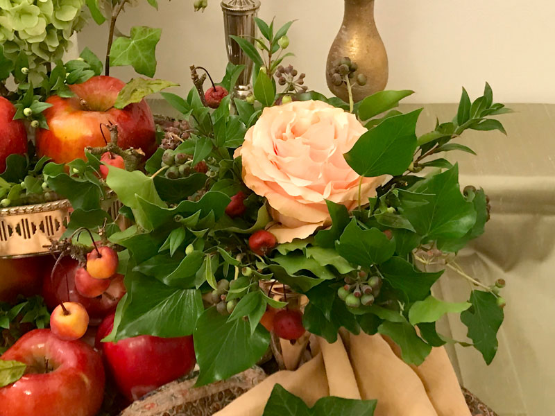 Sofreh with branches of crab apples around a spectacular single rose