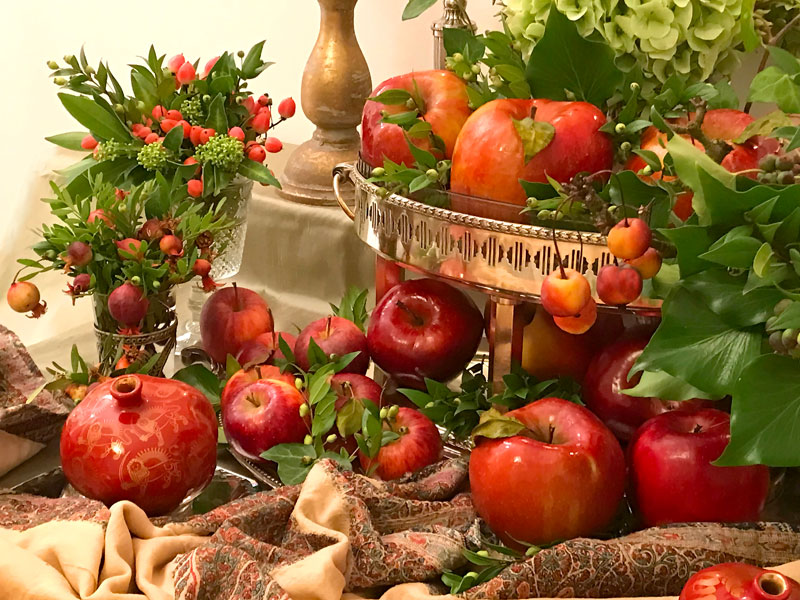 Sofreh with a bright red ceramic pomegranate embellishing the corner