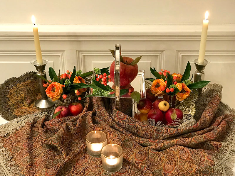 Sofreh with candles and oversized apples