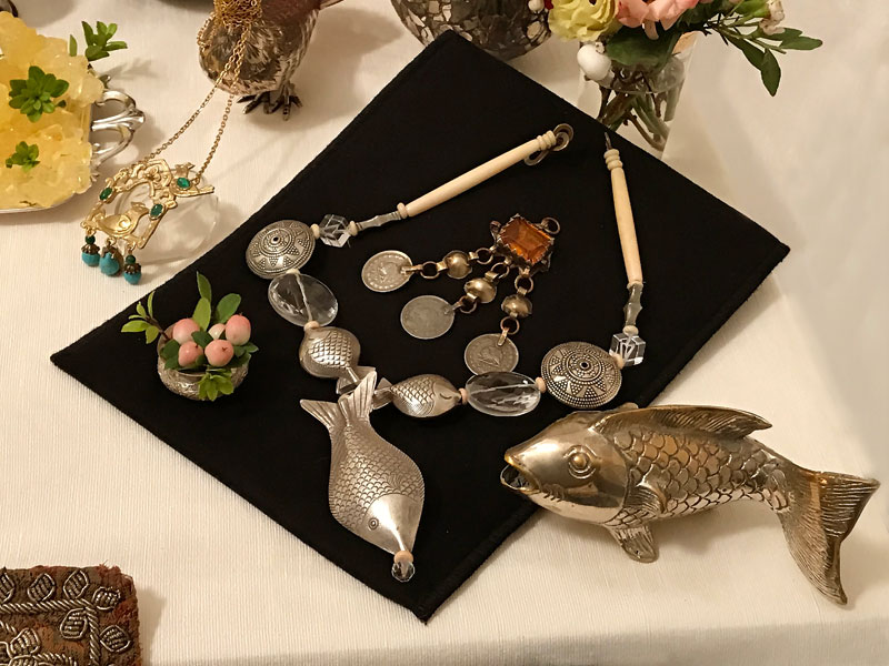 elegant necklace made of antique beads and statuettes of fish