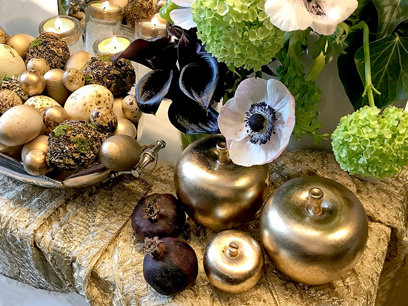 stylized sculpted gold-finish apples and miniature dried pomegranates