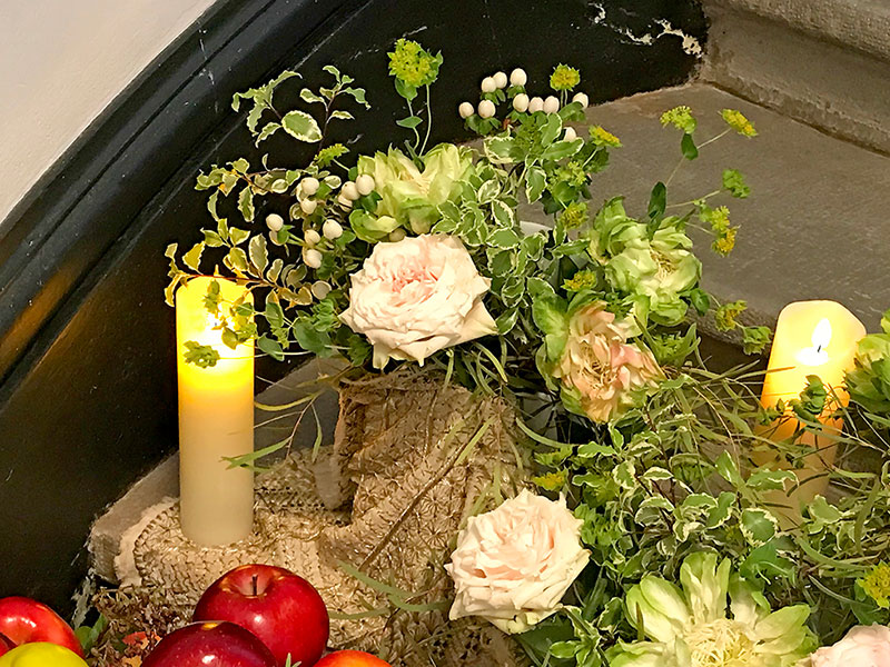 bouquet  and candles on textile
