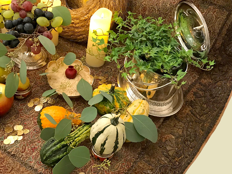 sprigs of Eucalyptus and a softly illuminated pot of delicate trailing ivy