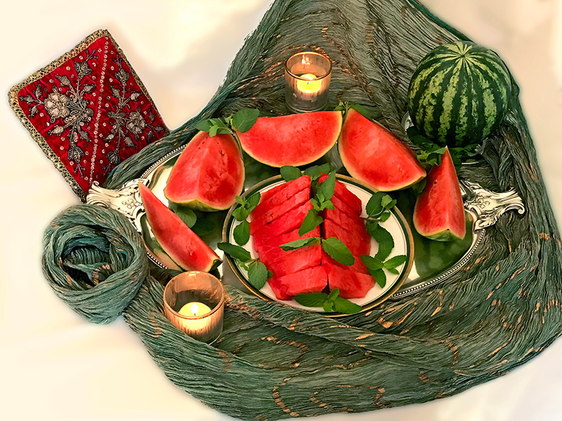 Watermelon with mint leaves, on Indian textile