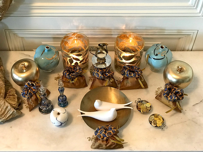 Rosewater, tea lights, ceramic birds, and bonbonnieres
