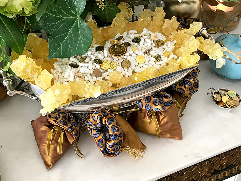 silver container of sugared almonds, crystal sugar, and gilded coins