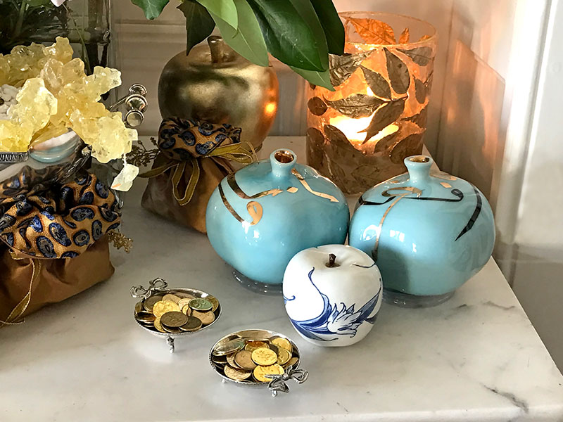 Ceramic pomegranates, gilded coins, bonbonnieres, and tea light