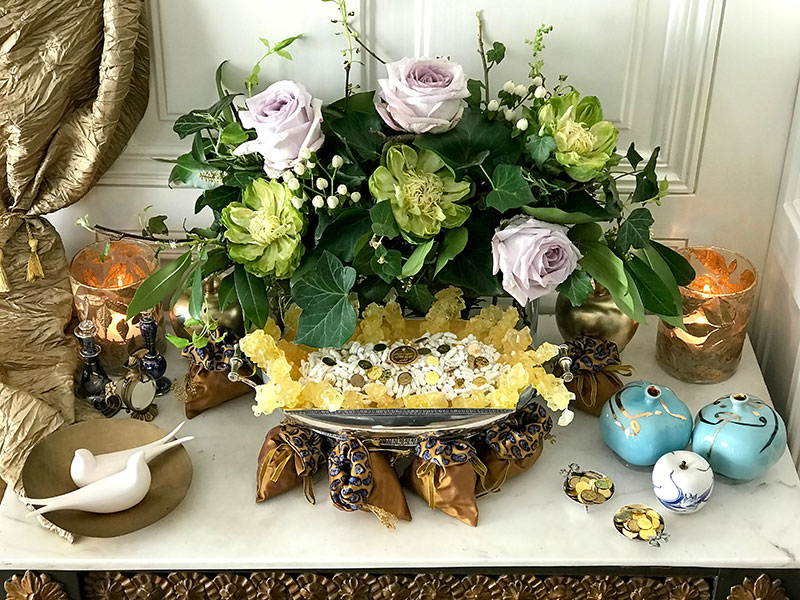 Sofreh of roses and foliage, sugared almonds, gilded coins and pomegranates
