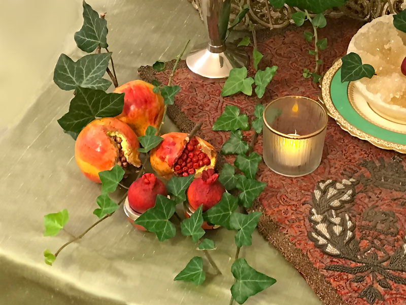 pomegranates embellished with sprigs of trailing ivy