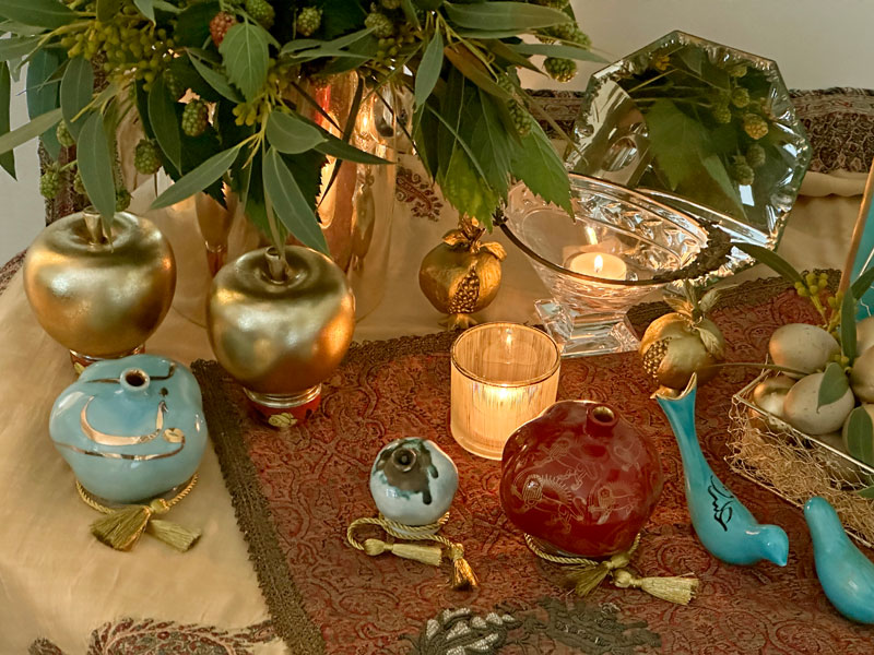 gold-finish sculptured apples and sculptured whole and gold-finish open pomegranates