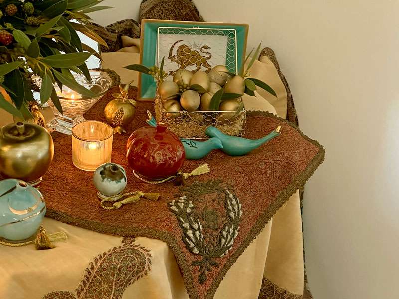 delicate open box, containing gold-tinted eggs, a symbol of fertility.   A pair of stylized ceramic birds represents the couple
