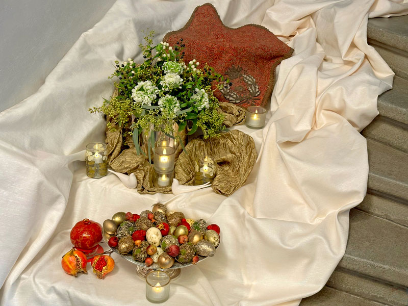 Tea lights (presented in elegant holders), decorated eggs and sculptured pomegranates