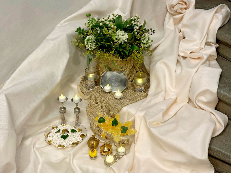 This is the overall view of the first sofreh-ye aqd, which has a soft and subtle colour scheme, showcasing ivory and muted-gold tones.