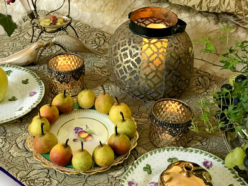 A charming antique gold-rimmed porcelain plate with dainty fruit motifs showcases a dozen miniature pears
