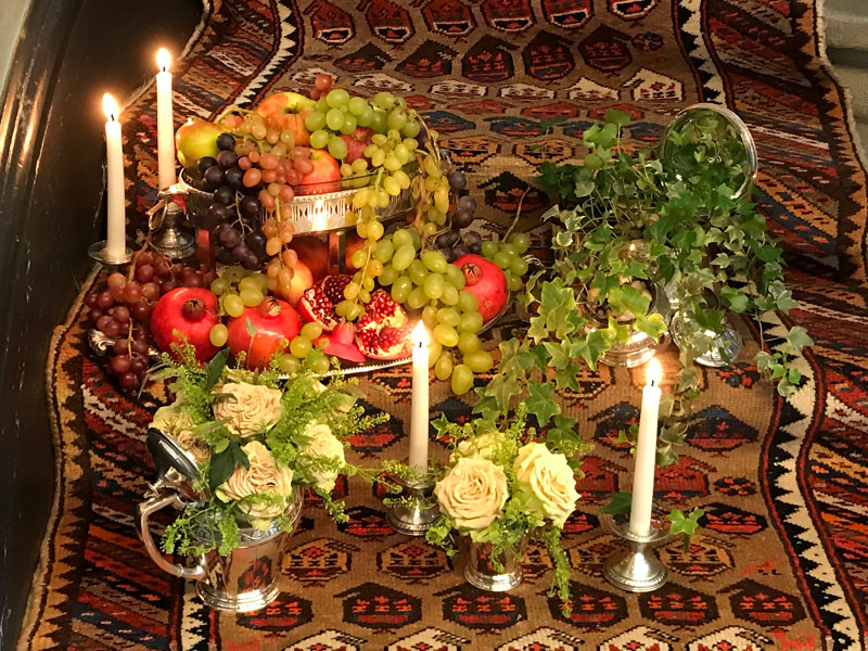 An antique Persian tribal rug with a stylized paisley design covers the staircase