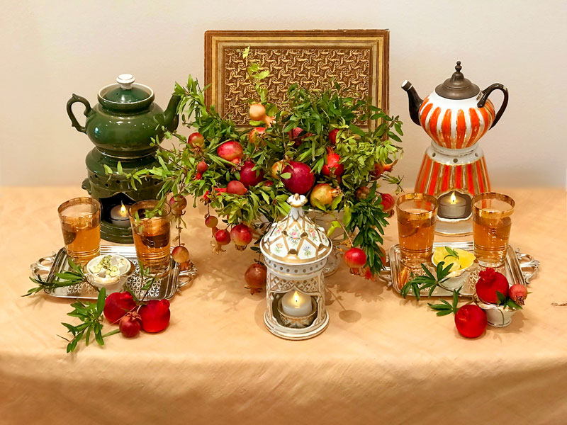 Two French antique tisanières replace the traditional samovar to prepare tea, served with sweets
