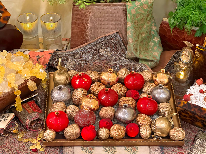 antique gold-framed tray presents miniature sculptured pomegranates in red and metallic silver and gold