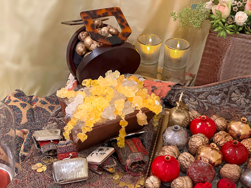 handbag made of wood with an imitation tortoiseshell handle houses a variety of gold-tinted eggs