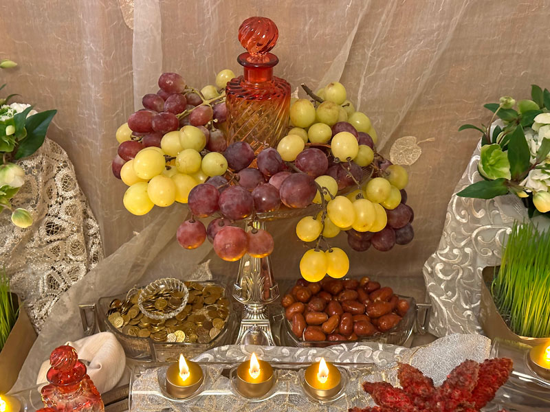 antique flask of vinegar, embellished with gracefully hanging bunches of green and red grapes