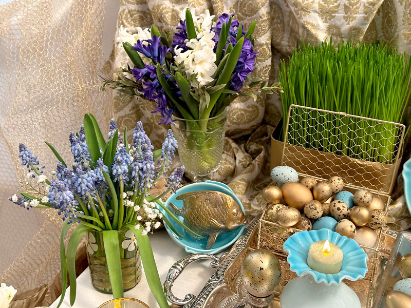 two bouquets of spring flowers, namely white and striking blue hyacinths mixed with foliage
