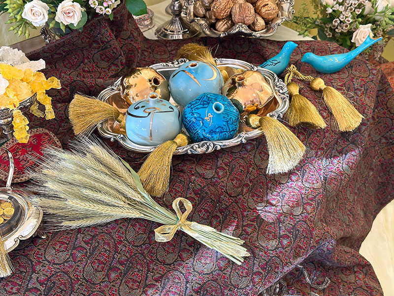 antique silver-plated container of ceramic pomegranates