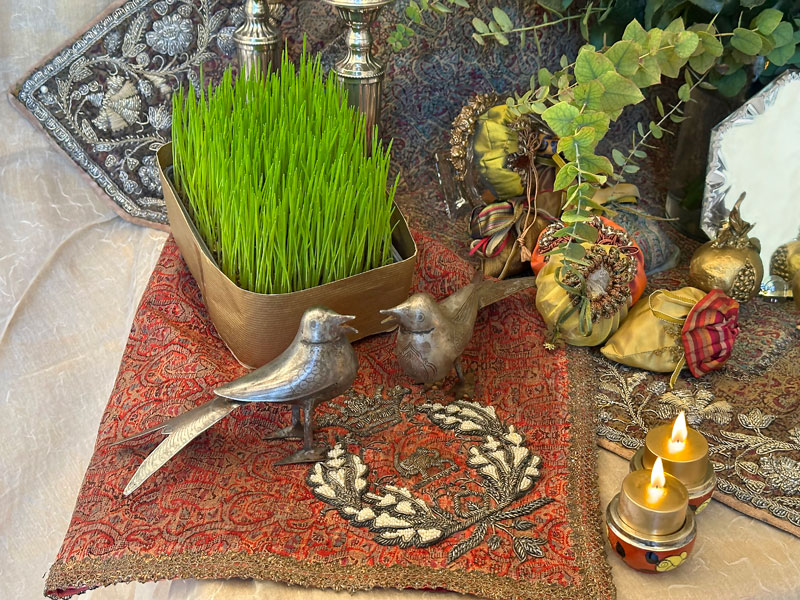 a block of germinated wheat with a pair of stylized birds