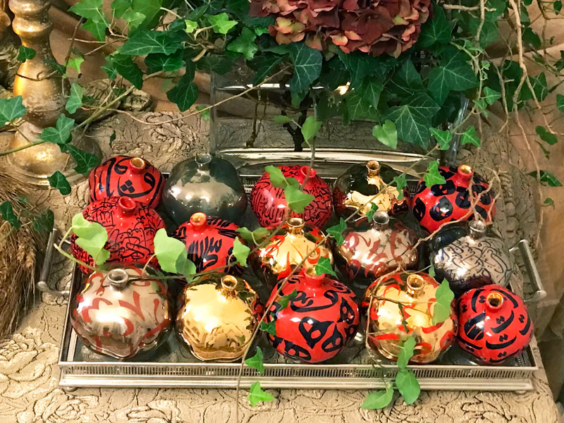 tray of gold, silver and red sculptured pomegranates