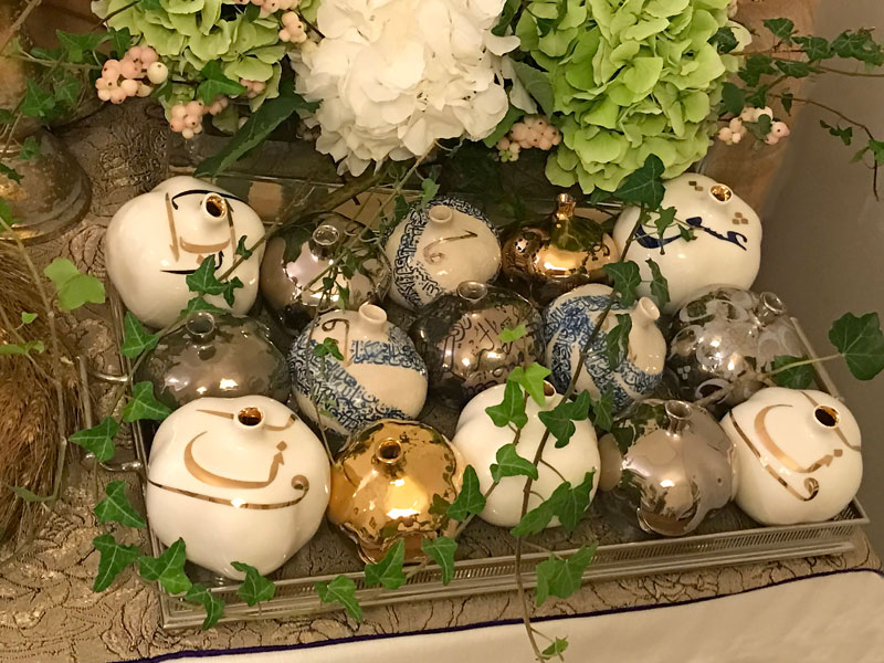 tray of gold, silver, blue and white sculptured pomegranates